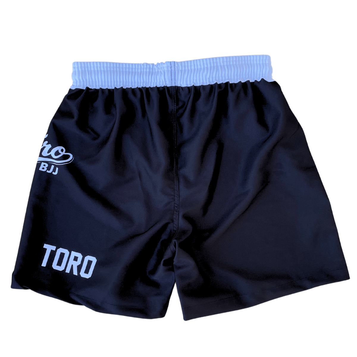 Back view of black Toro 2027 Super Short BJJ shorts with a white elastic waistband and Toro branding