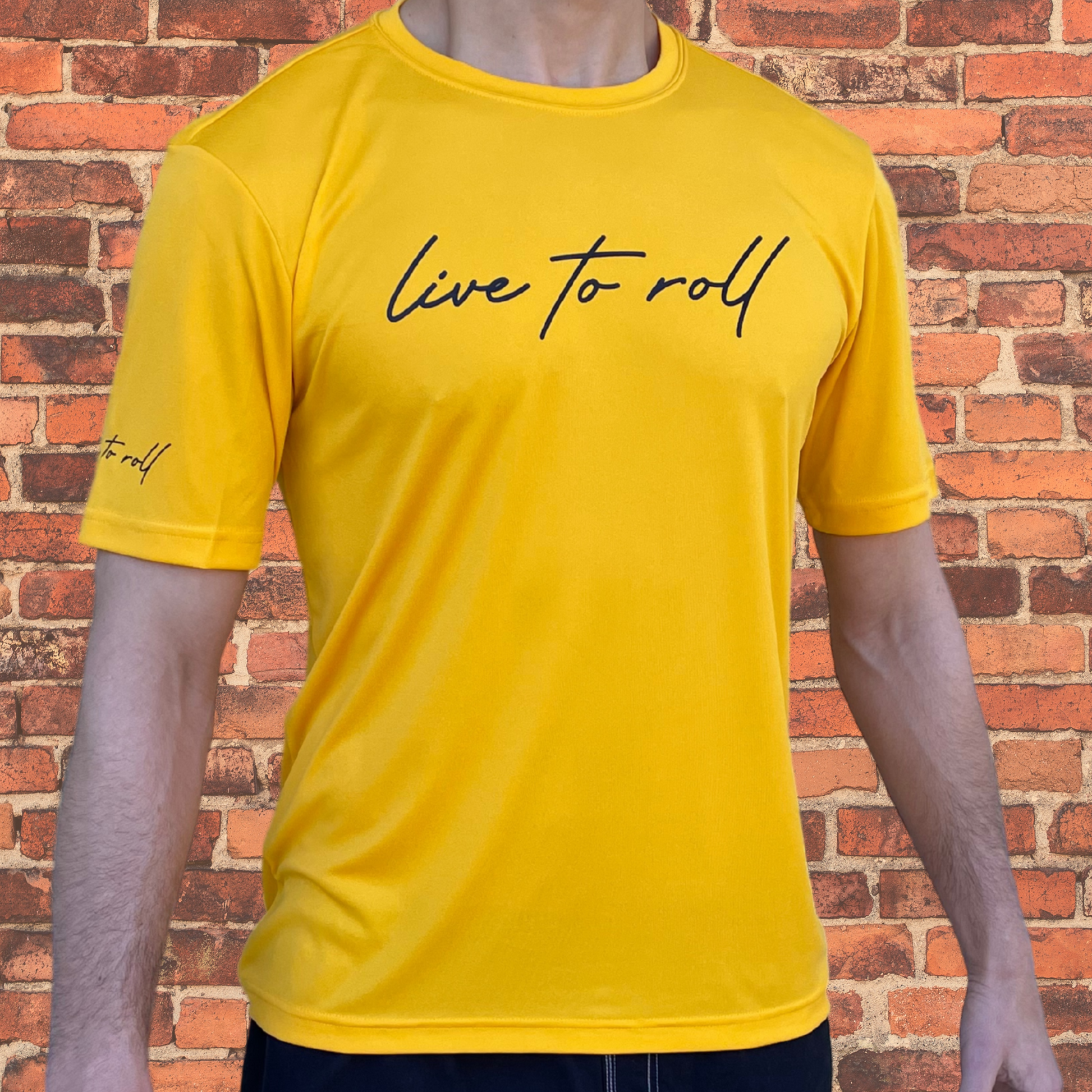 Toro BJJ Loose Fit Rash Guard in gold, featuring “Live to Roll” text on chest and sleeve, short sleeve design for NoGi Jiu-Jitsu and under your BJJ gi