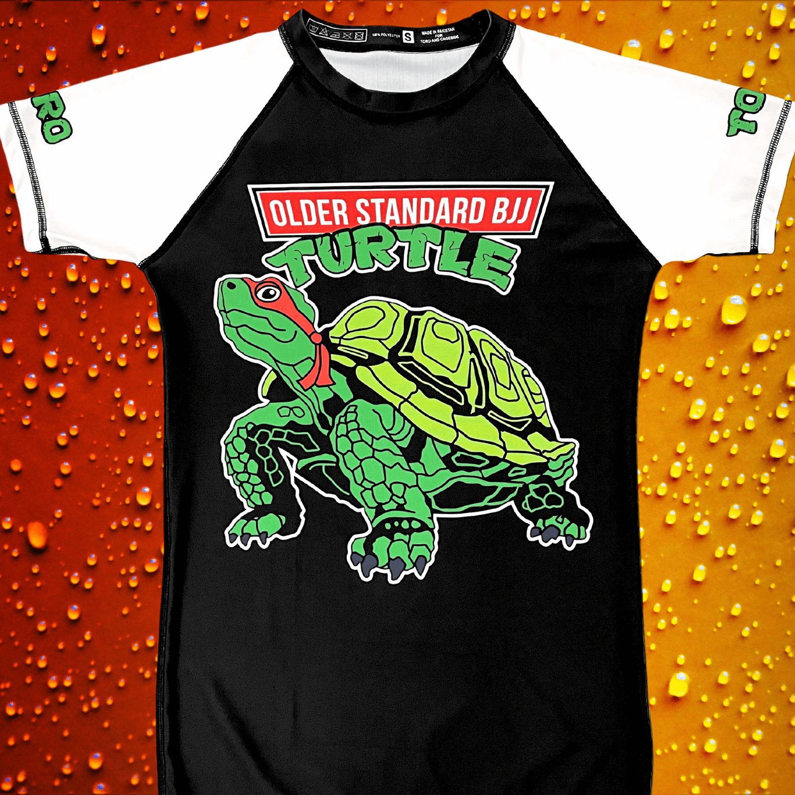 Toro BJJ rash guard with a green cartoon turtle and "Older Standard BJJ Turtle" text on a black and white short sleeve design.