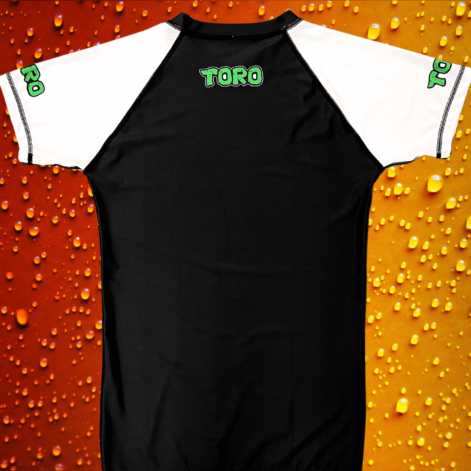 Back view of Toro BJJ rash guard with white sleeves, black body, and green TORO text centered at the upper back and on both sleeves.