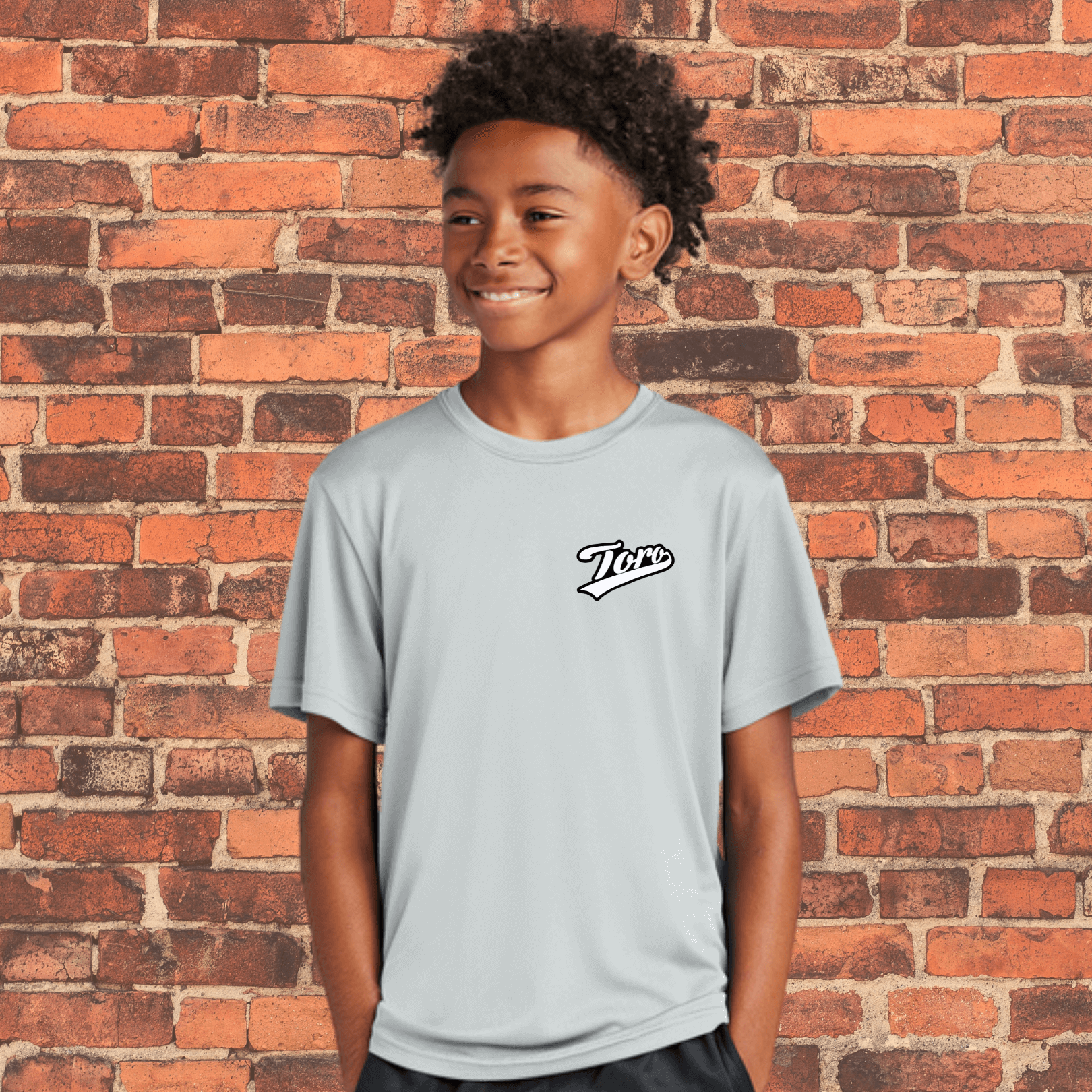 Smiling youth athlete wearing Toro grey belt BJJ rash guard in loose fit for kids' NoGi training