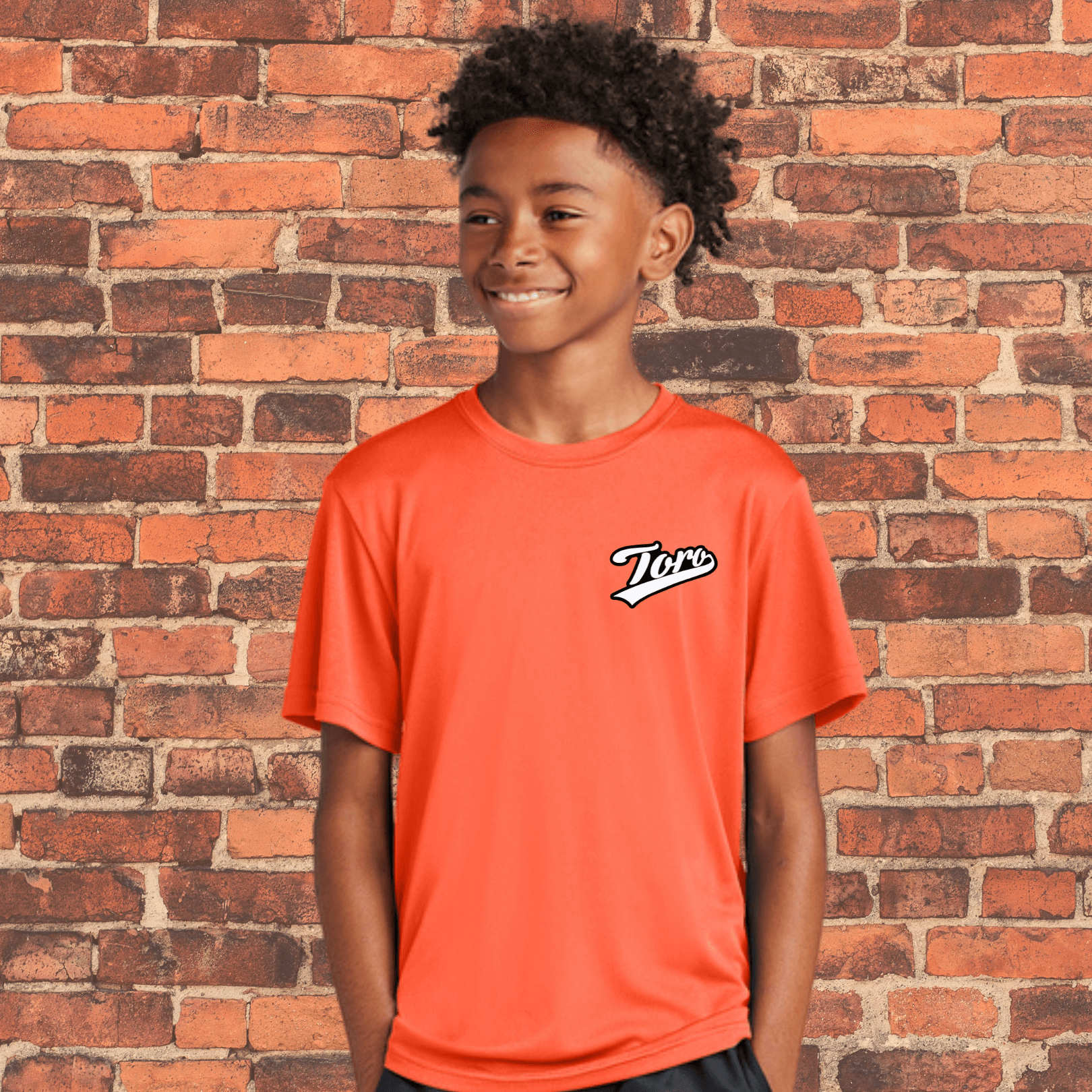 Youth athlete wearing orange ranked BJJ rash guard by Toro, loose fit design ideal for NoGi training or layering under gi