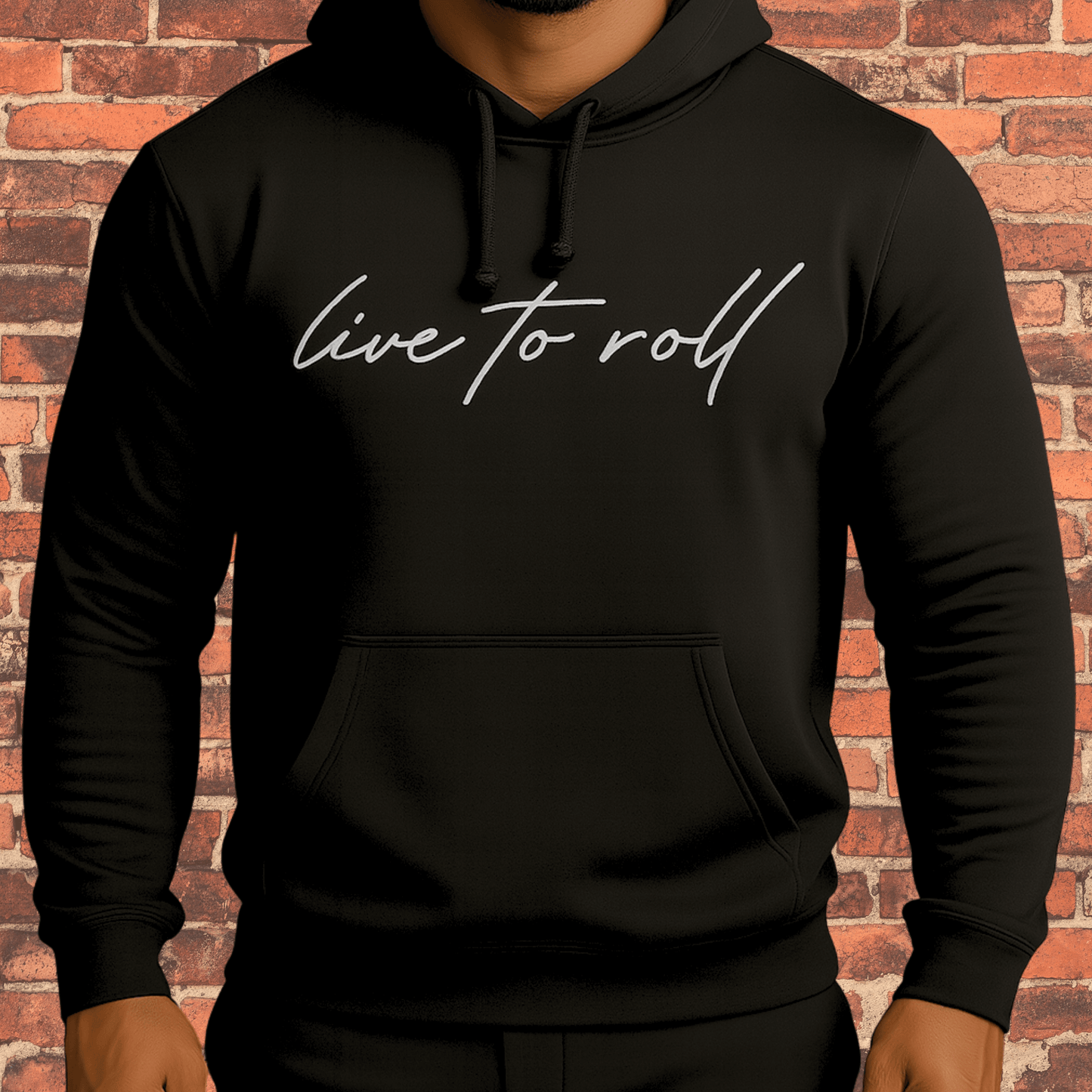 Toro “Live To Roll” Hoodie Black with white logo on model against brick background