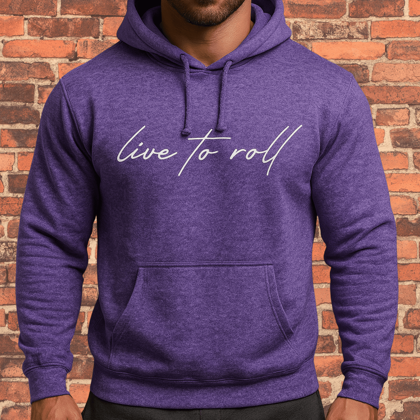 Toro “Live To Roll” Hoodie Heather Purple with white script logo on brick wall background.