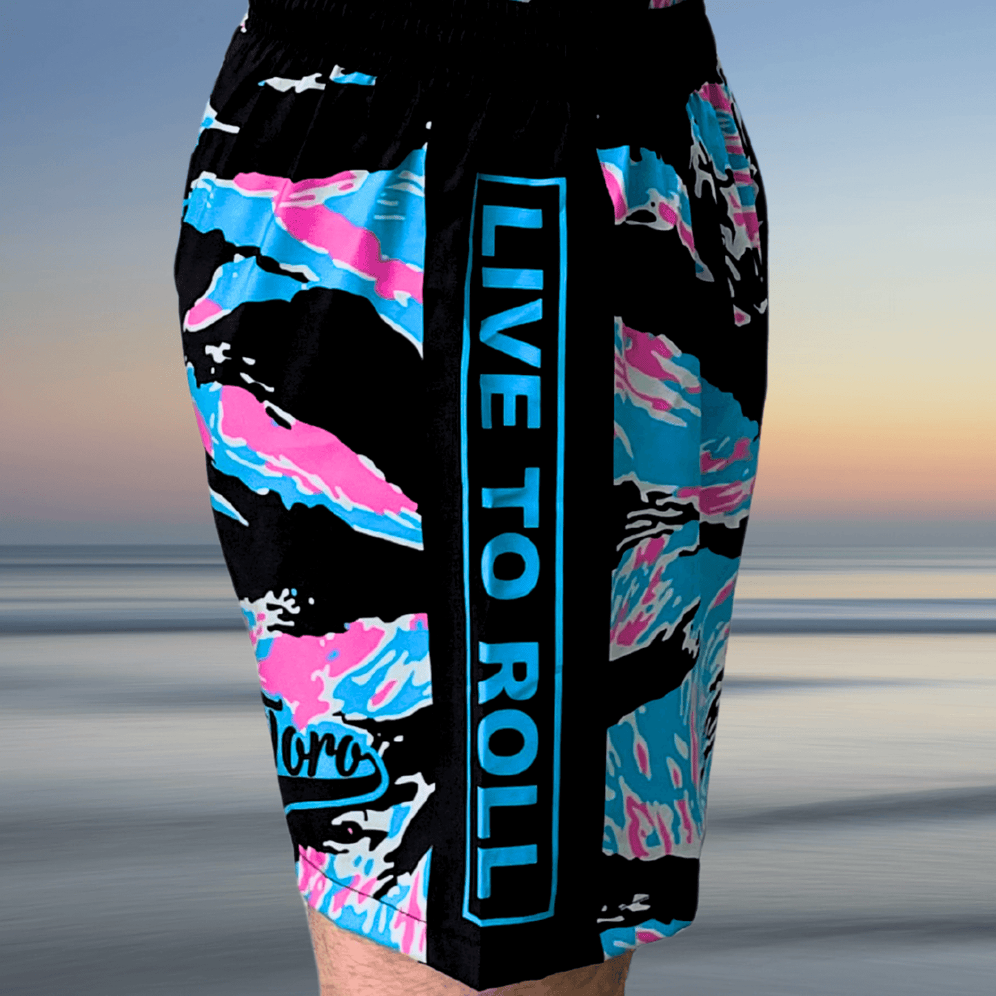 Miami Camo Super Shorts with bold "Live to Roll" text and pastel detailing.