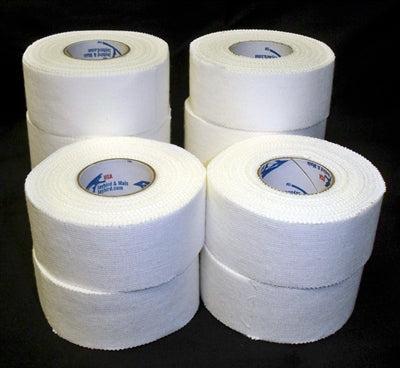 Stacks of white athletic tape rolls on a dark background, commonly used for sports like BJJ and MMA for joint support and securing gear