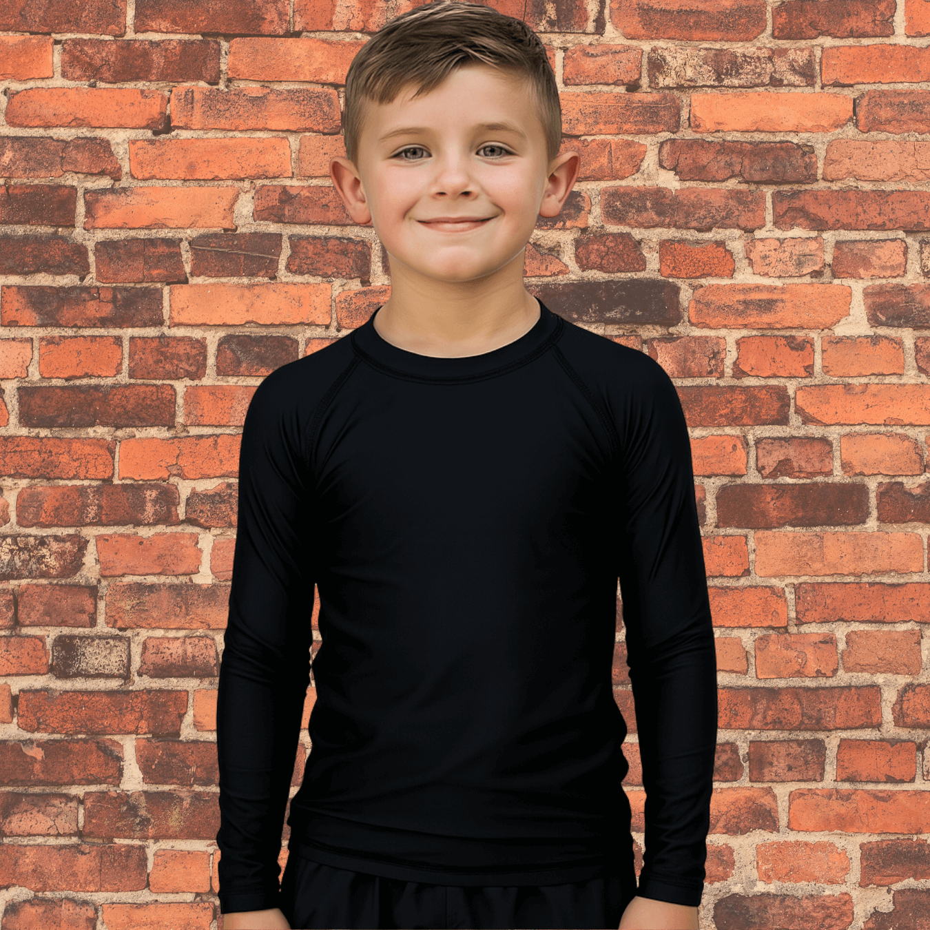 Young athlete wearing Toro Youth Black Label Long Sleeve BJJ Rash Guard standing against brick wall background