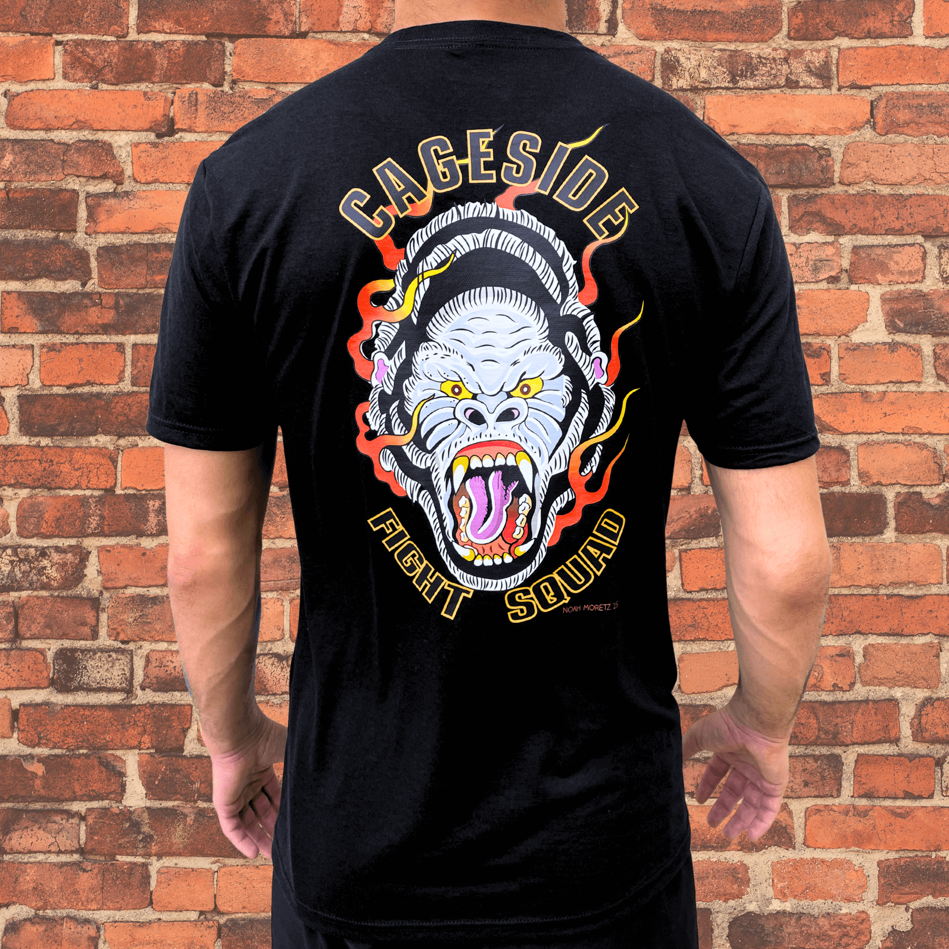 Back view of Cageside Fight Squad shirt with large flaming gorilla design and bold yellow lettering