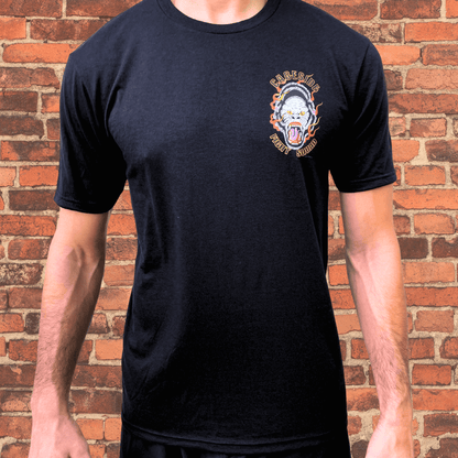 Black Cageside Fight Squad t-shirt with flaming gorilla logo on chest, modeled against brick wall background