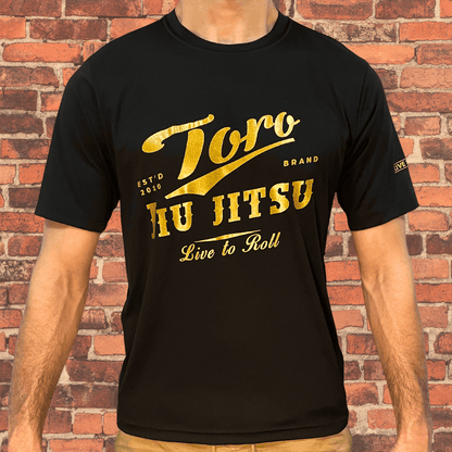 Man wearing the Loose-Fit Toro BJJ Classic Rash Guard with bold gold Toro Jiu-Jitsu logo on front