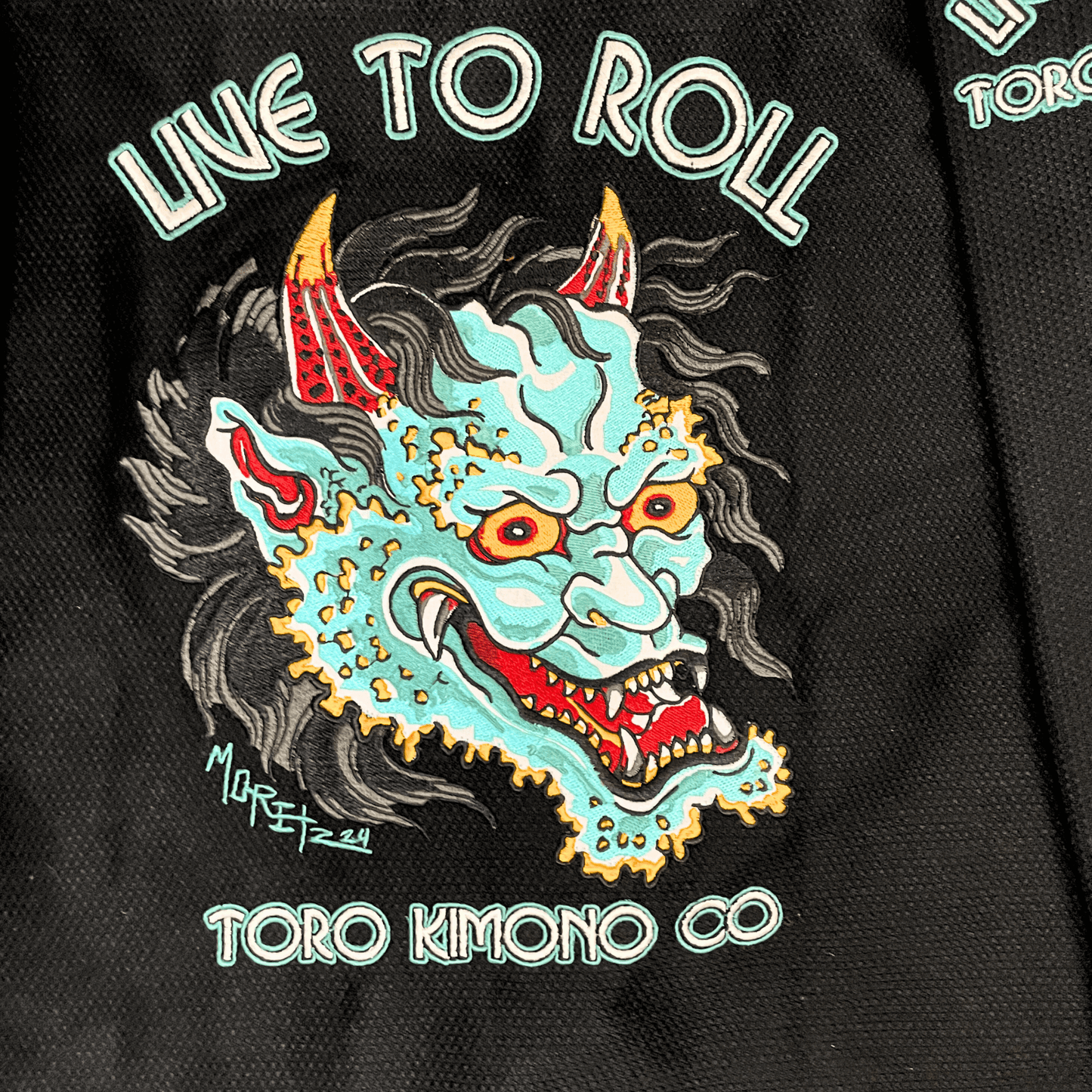 Green Oni BJJ Gi detailed Oni embroidery with Live to Roll text, IBJJF approved