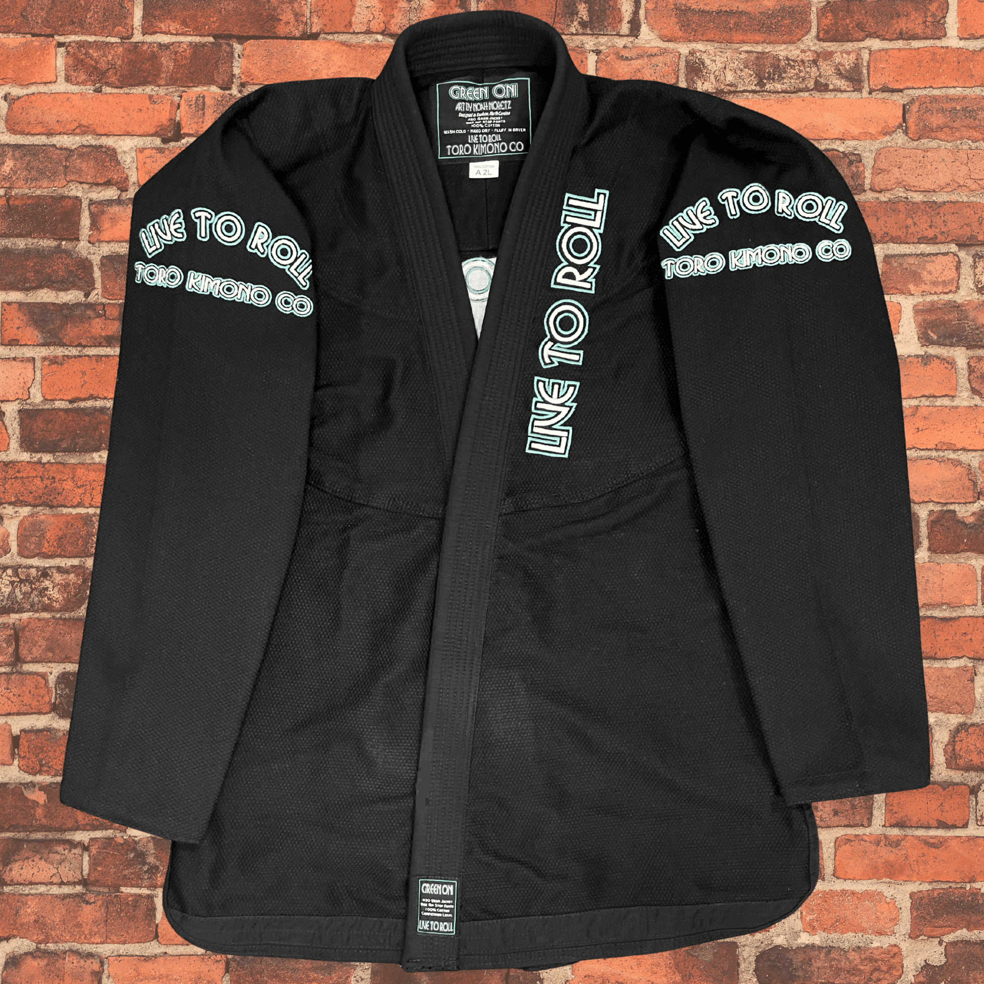 Green Oni BJJ Gi jacket front view with Live to Roll text, IBJJF approved