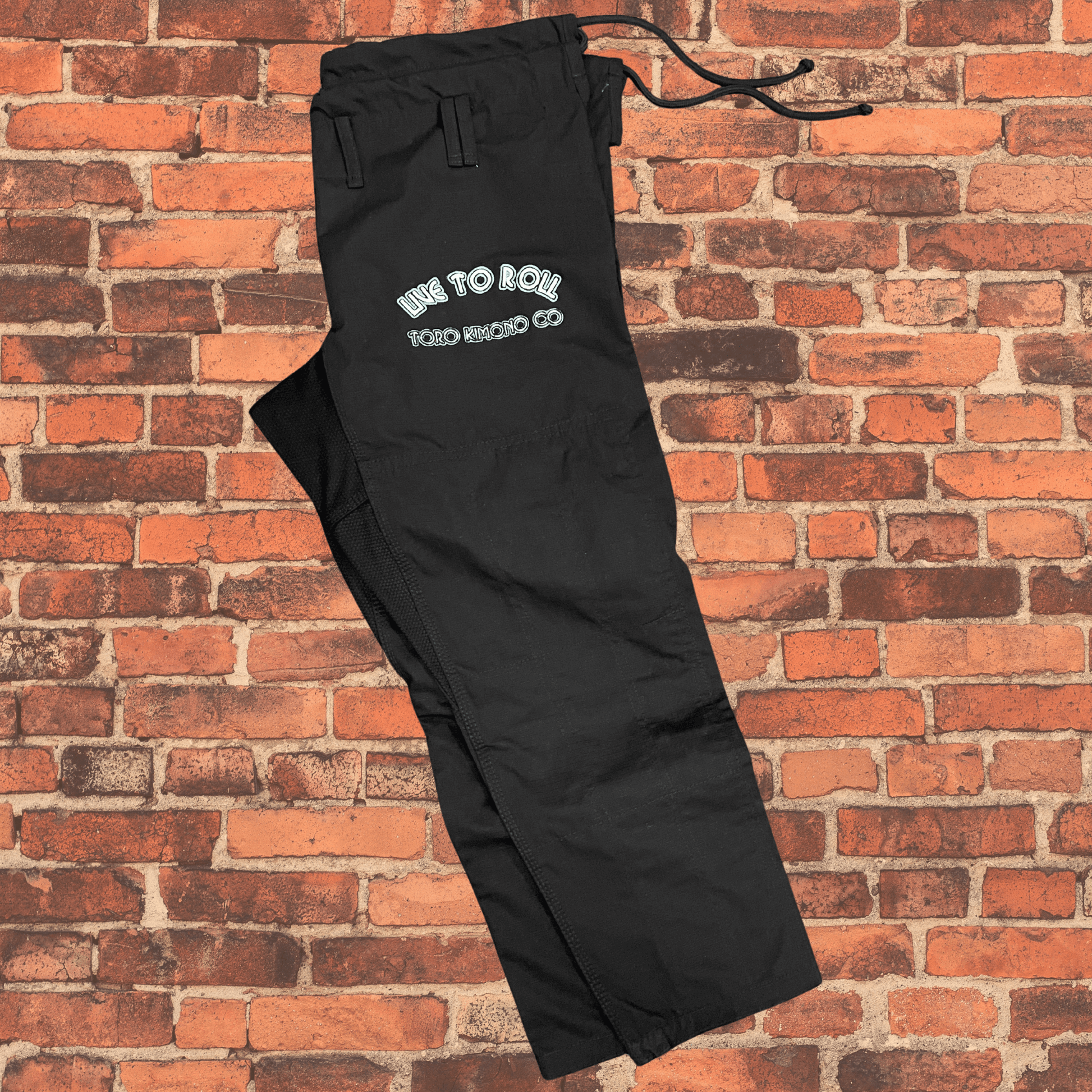 Green Oni BJJ Gi pants side view with Live to Roll embroidery, IBJJF approved