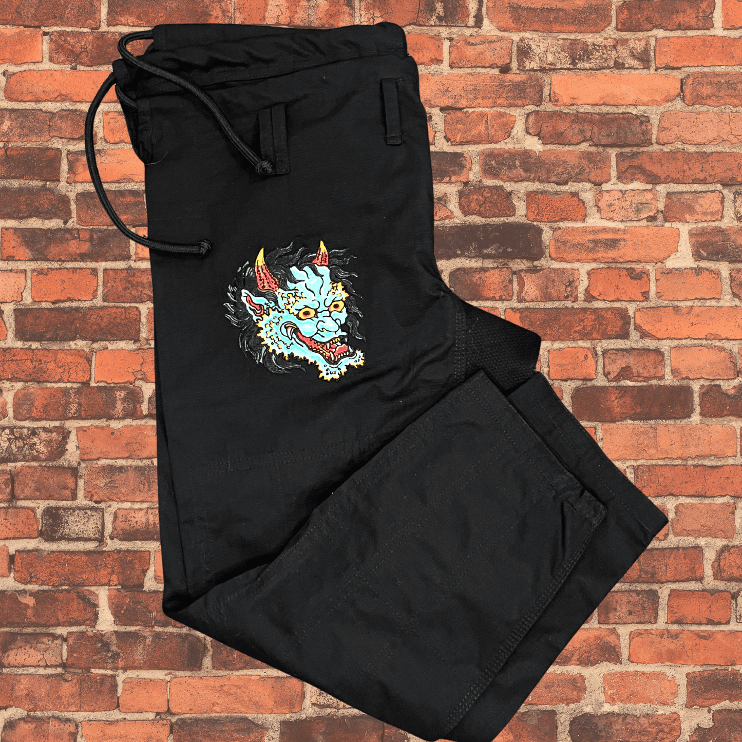 Green Oni BJJ Gi pants with embroidered Oni face design, IBJJF approved