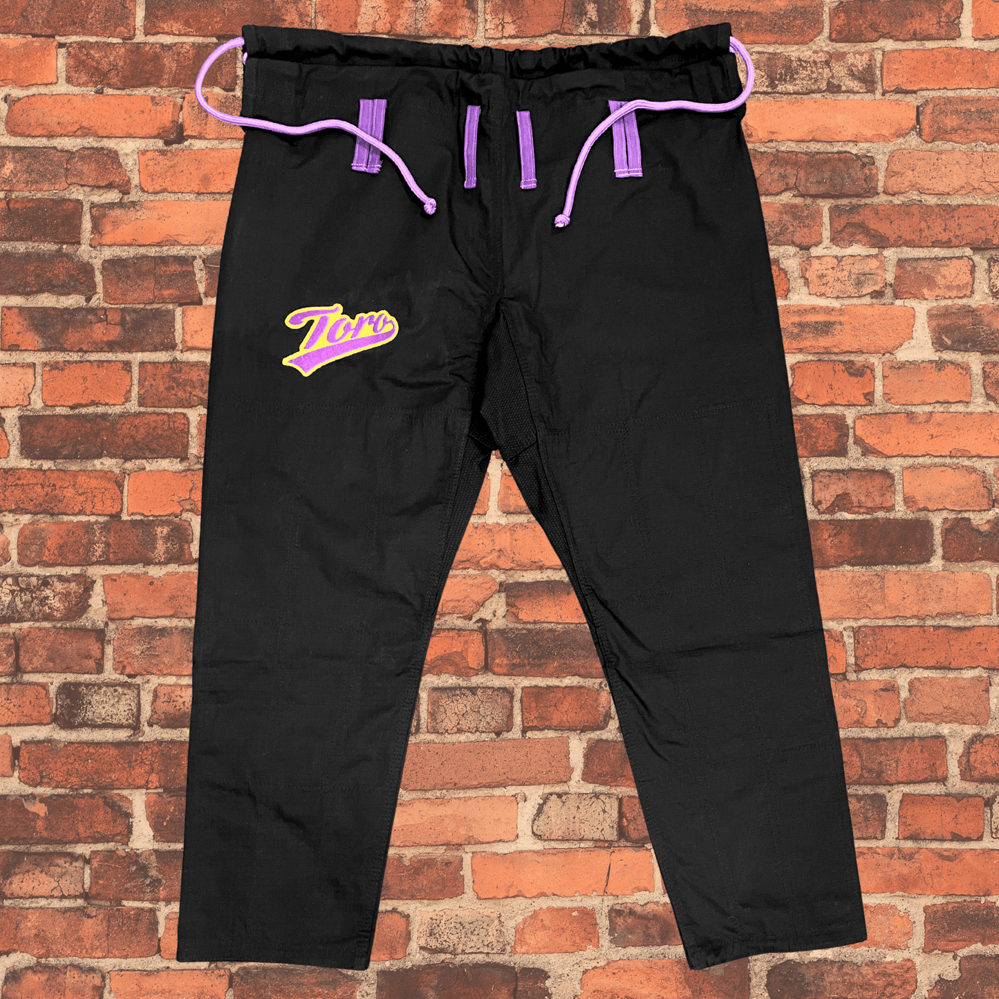 Black BJJ Gi pants with purple drawstring and Toro gold and purple logo, IBJJF approved Purple & Gold Gi
