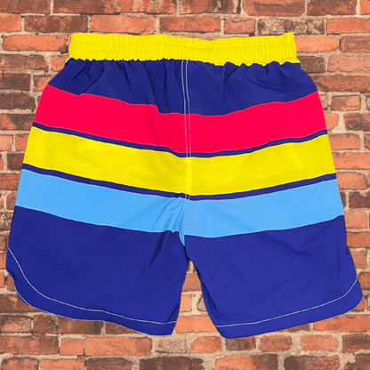 Back view of Toro BJJ Summertime Super Shorts featuring colorful horizontal stripes in red, yellow, blue, and navy with a yellow waistband.