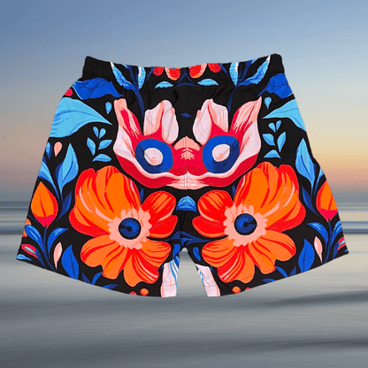 Back view of Toro BJJ Tiki Tahiti Super Shorts with bold tropical print, showcasing large orange and red flowers with blue leaves and abstract patterns.