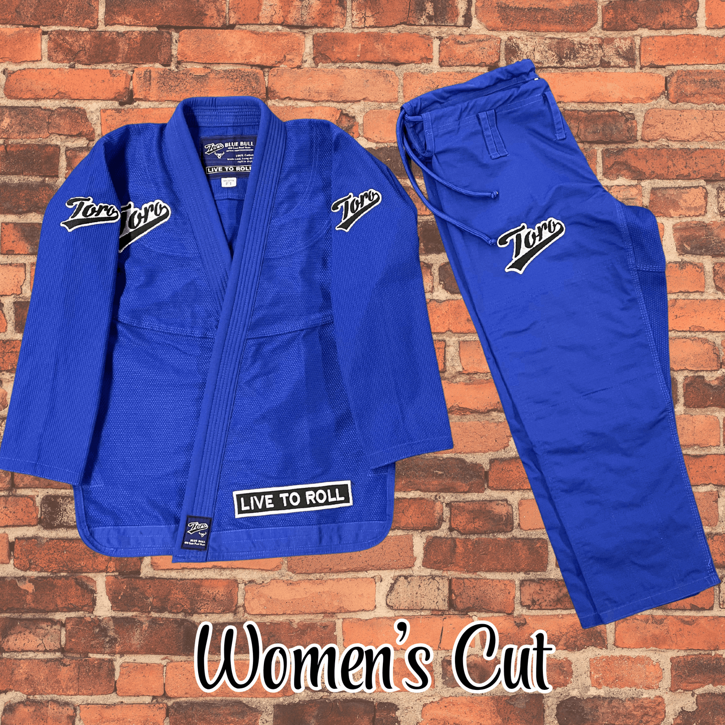 Toro BJJ Blue Bull women’s cut gi set with blue jacket and pants, Toro patches on shoulders, chest, pants, and Live to Roll patch.