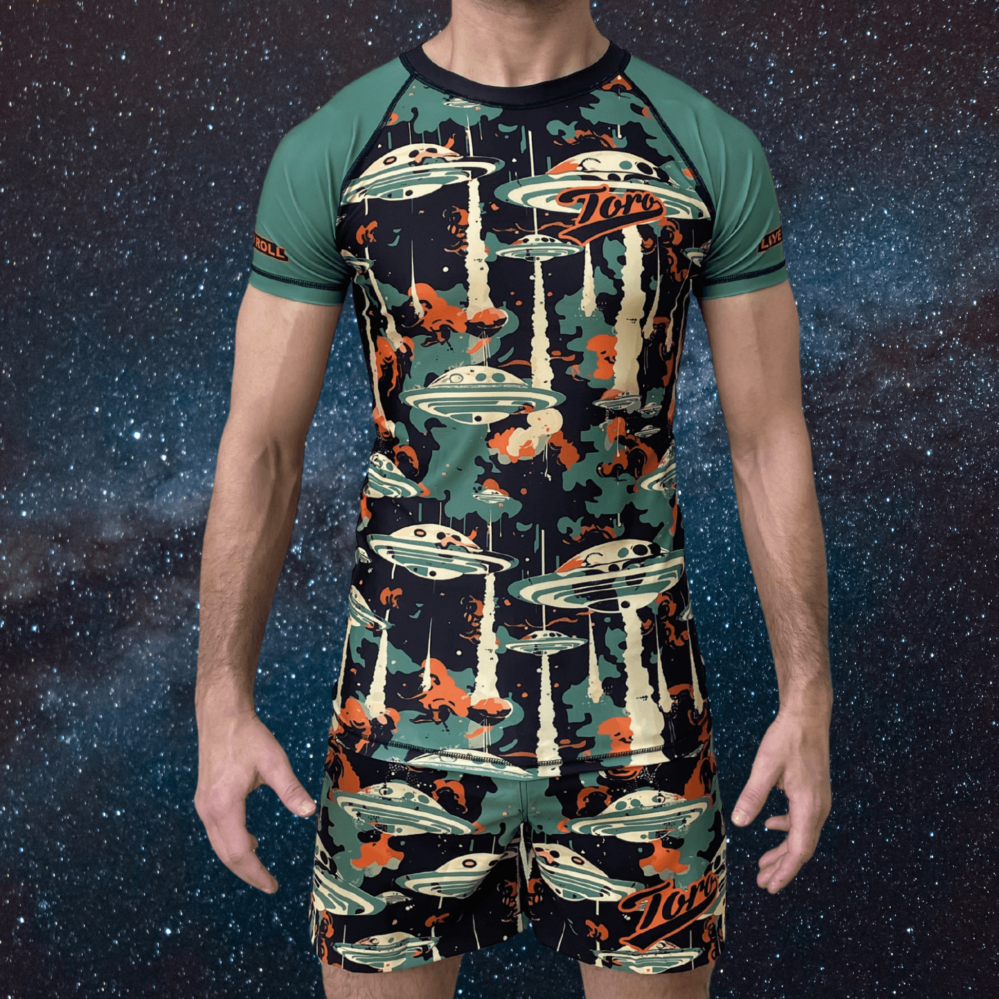 Front view of athlete wearing the Toro BJJ Cosmic rash guard and matching shorts with alien invasion print