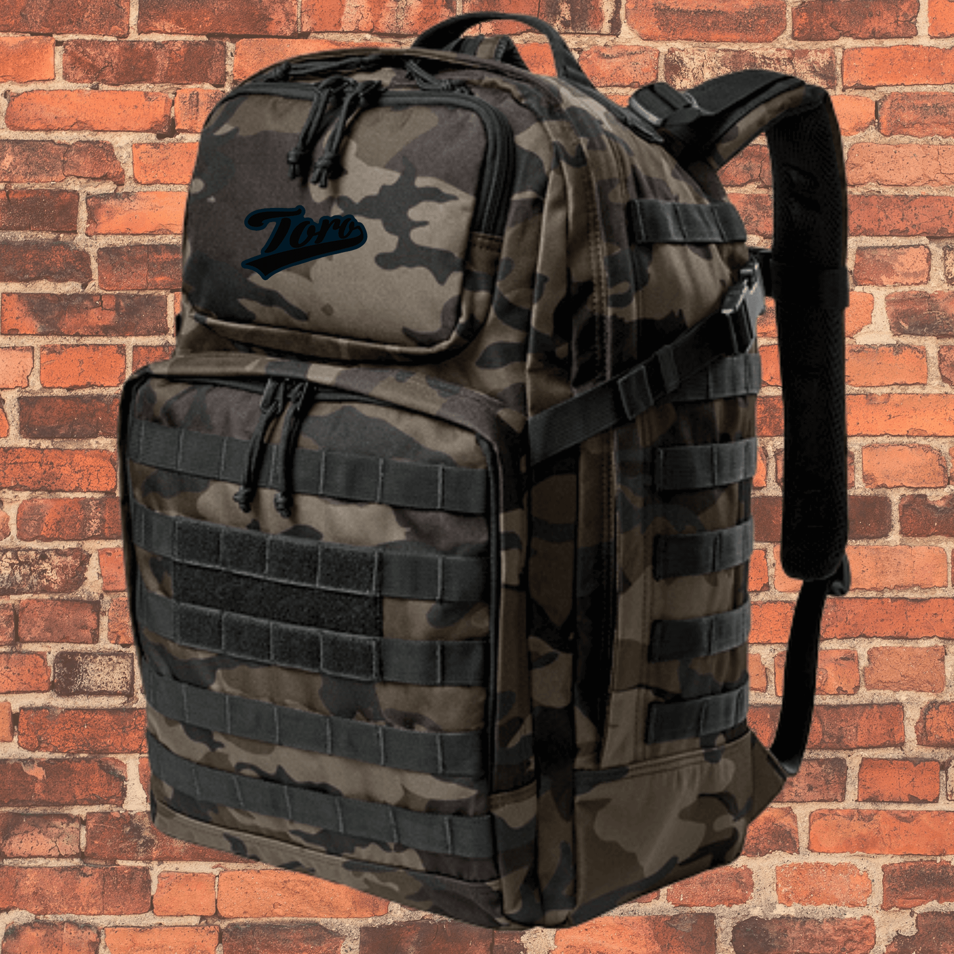 Toro Large Tactical Backpack Dark Camo with Toro logo, daisy chain straps, and zippered front pockets.