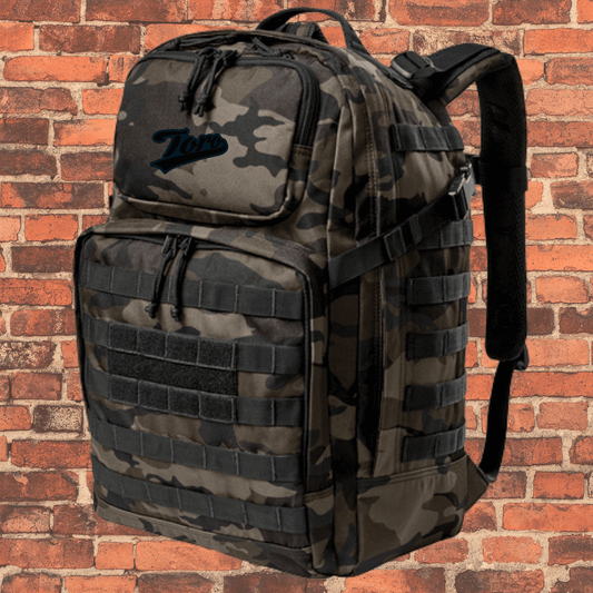 Toro Large Tactical Backpack Dark Camo with Toro logo, daisy chain straps, and zippered front pockets.