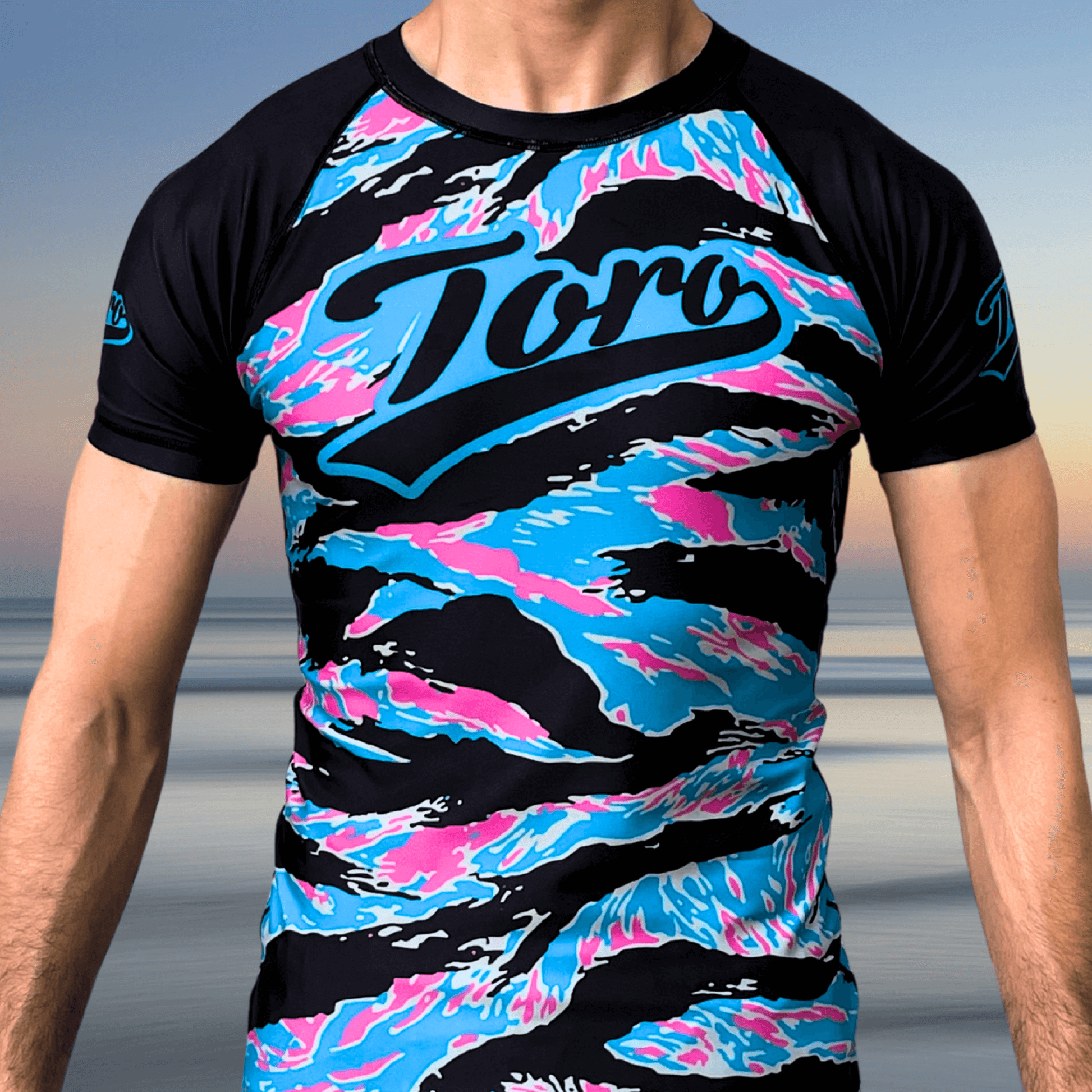 Miami camo BJJ rash guard with black sleeves, Toro script logo, and pastel camo pattern