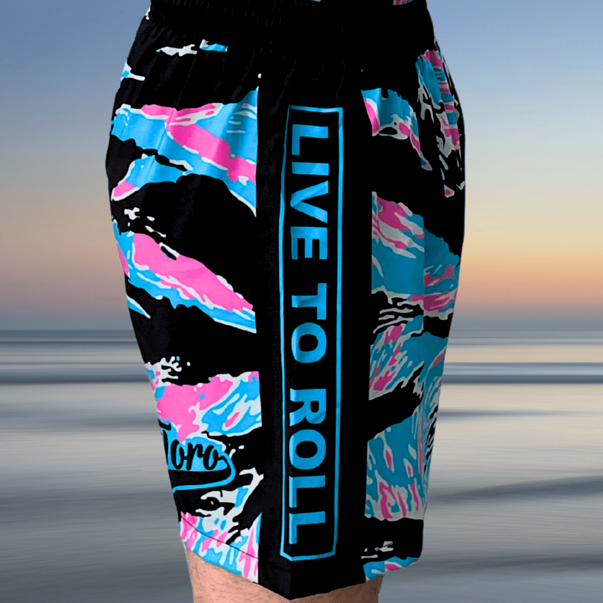 Miami Camo Super Shorts with bold "Live to Roll" text and pastel detailing.