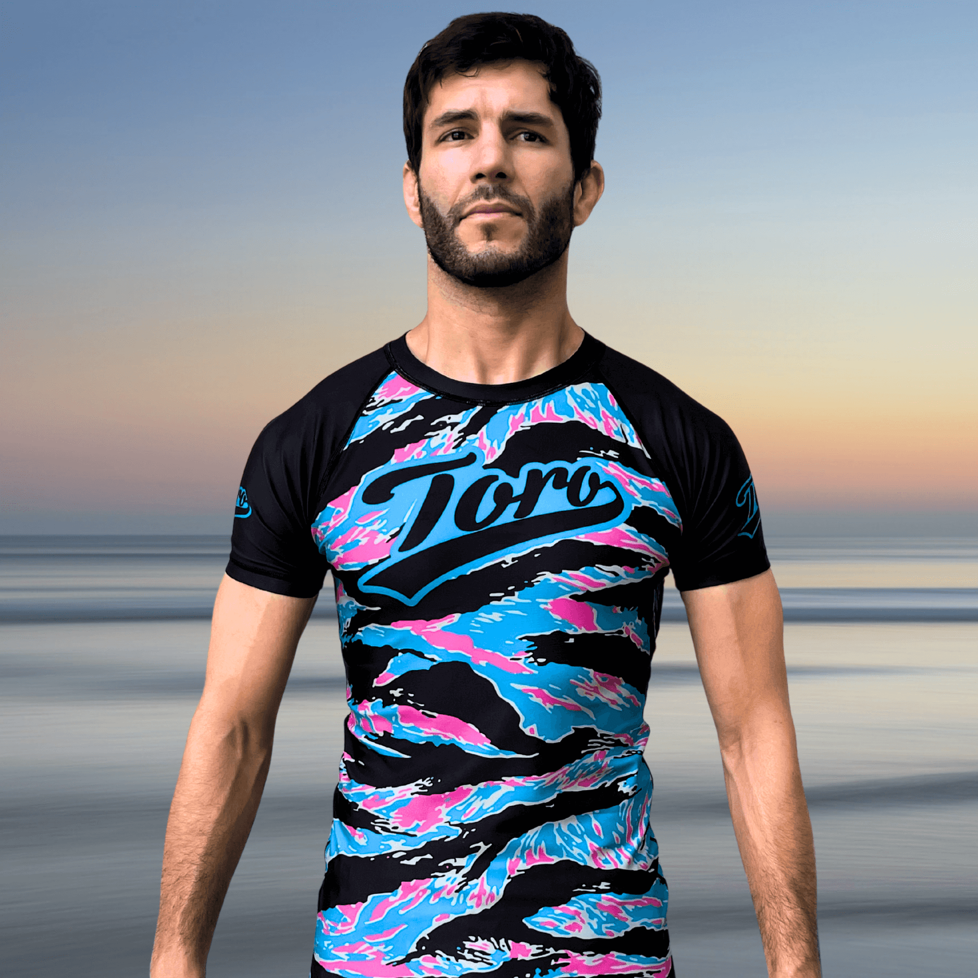 Front view of man wearing Miami Camo Toro BJJ rash guard in NoGi setting