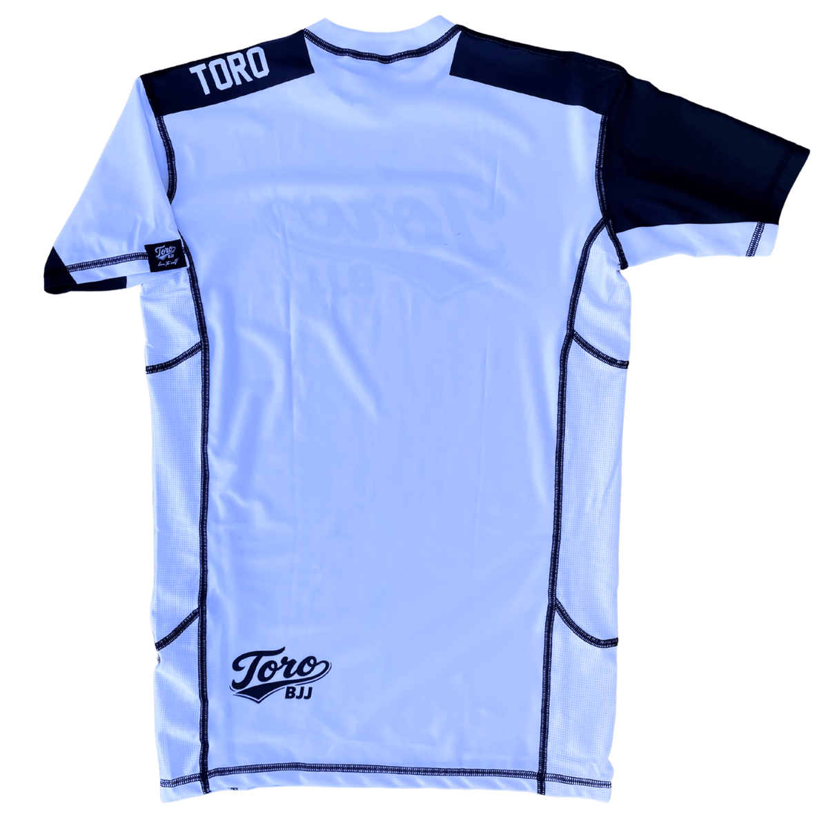Back view of Toro white belt ranked rash guard with black shoulders and lower back logo