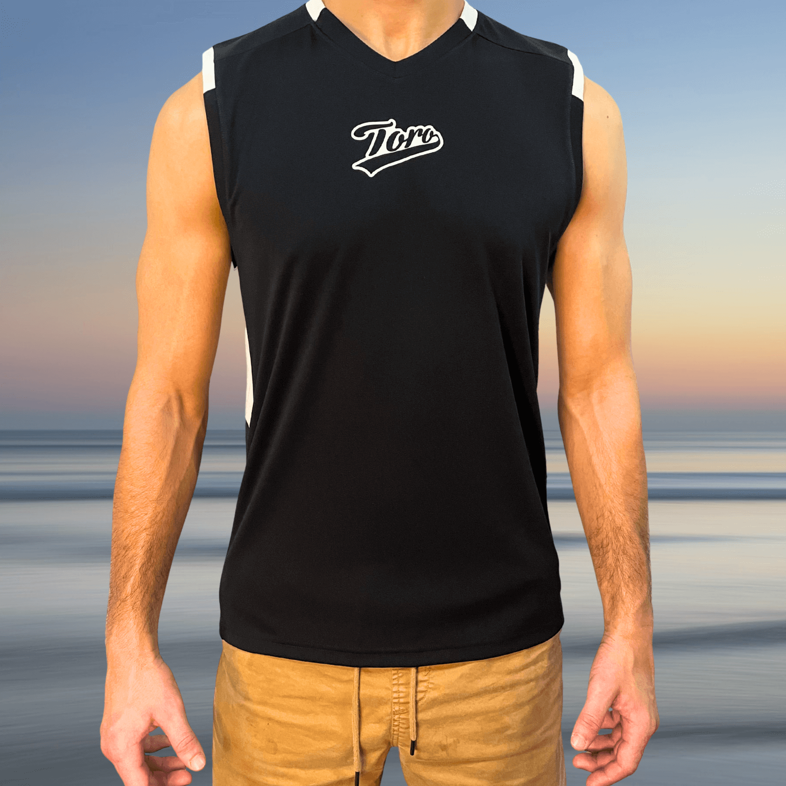 Man wearing the Toro Recycled Jersey front-facing, showing sleeveless black design with white Toro logo on chest