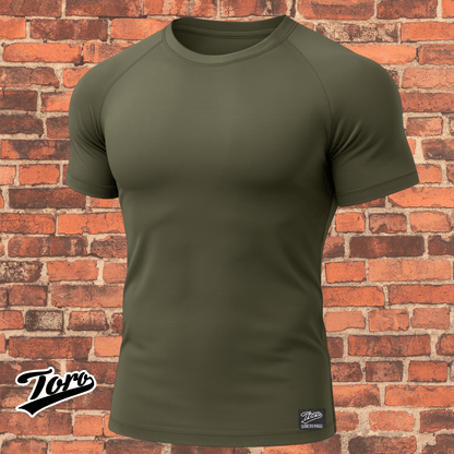 Olive drab Toro BJJ short sleeve rash guard against brick wall background, Black Label NoGi training top.