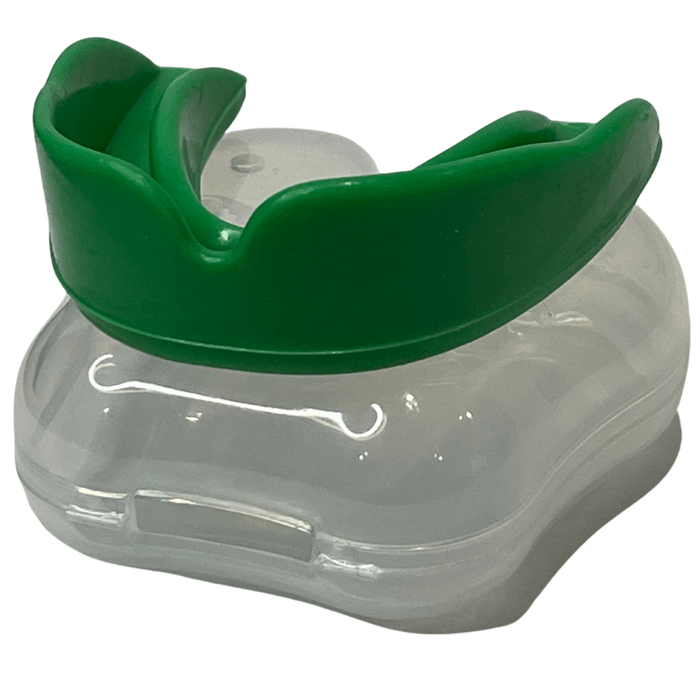 Green boil and bite mouth guard resting on clear storage case”